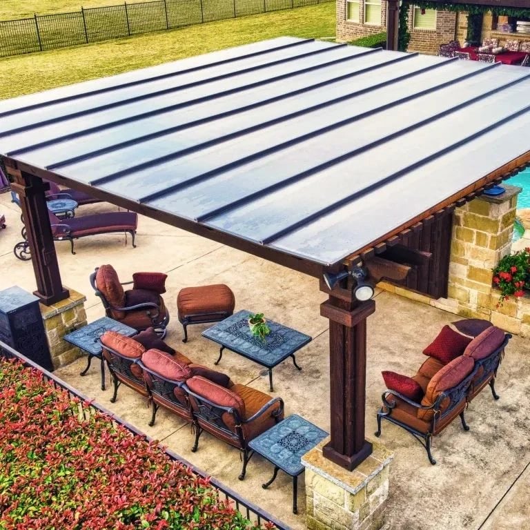 Bronze pergola roof cover over a furnished patio